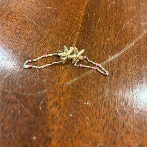 Gold starfish stud with pink beaded chain attached